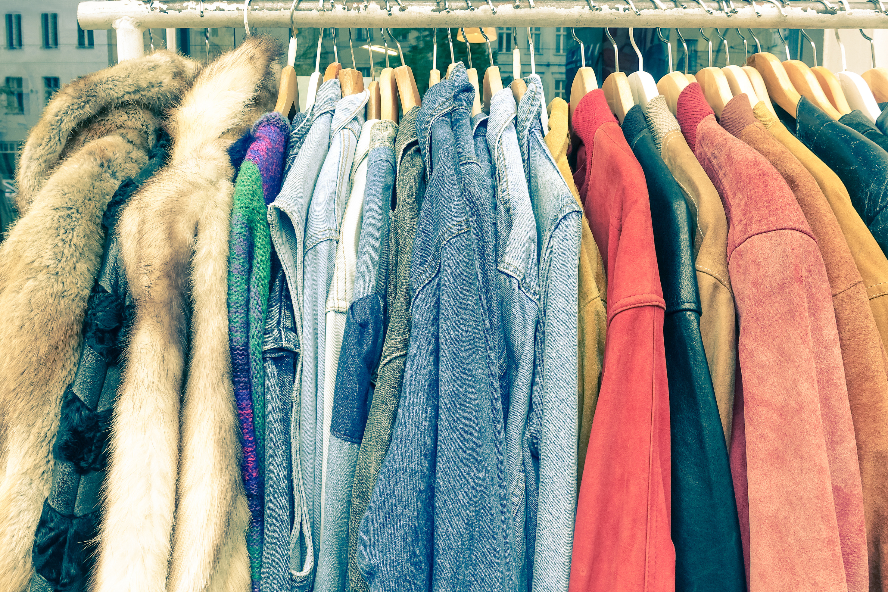 Vintage Second Hand Clothes Hanging on Shop Rack at Weekly Flea